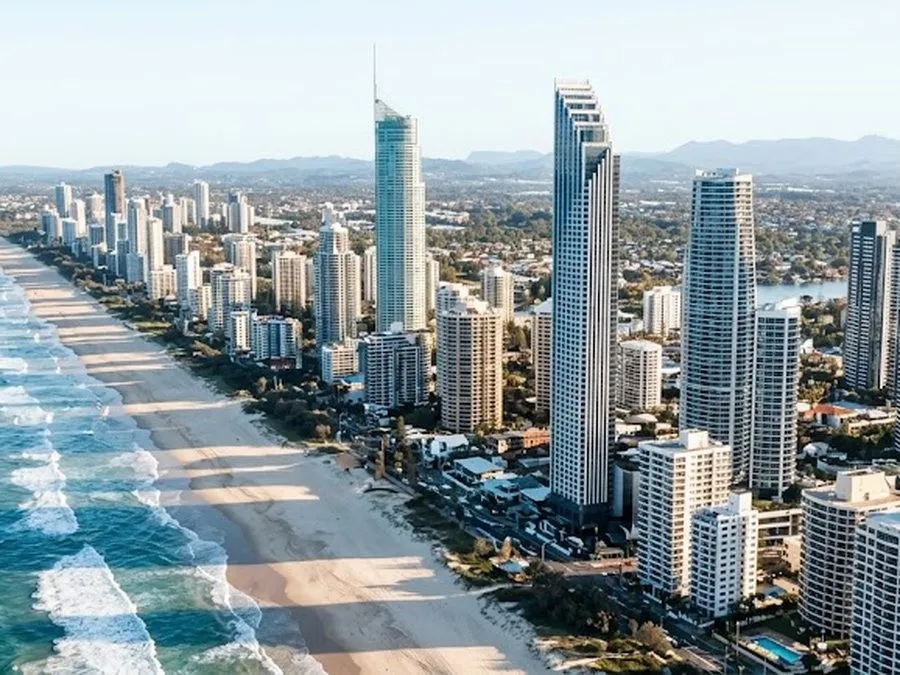 High-rise towers along a surf beach, seen from the air