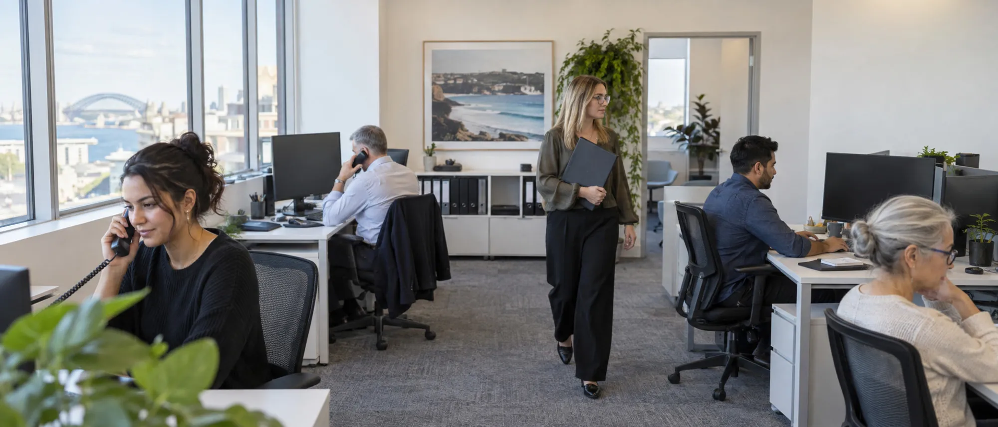 A small lending team working at desks in an open office